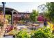 Outdoor dining area with colorful tables, chairs, and landscaping, creating a vibrant and inviting atmosphere at 2048 Meade St, Denver, CO 80211
