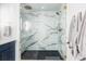 Glass enclosed shower with marble-look tile and black shower pan at 2048 Meade St, Denver, CO 80211