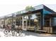 Bicycle and coffee shop storefront with benches, bicycle parking, and glass windows displaying the interior at 2048 Meade St, Denver, CO 80211