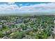 An aerial view of a suburban neighborhood with parks, recreational facilities, and tree-lined streets at 3245 S High St, Englewood, CO 80113