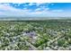 Aerial view of a neighborhood with tree-lined streets, homes and an educational campus at 3245 S High St, Englewood, CO 80113