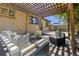 Backyard deck featuring a wooden pergola and outdoor seating area with plush cushions at 3245 S High St, Englewood, CO 80113