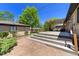 Backyard brick patio with tiered wood deck perfect for entertaining and enjoying outdoor living at 3245 S High St, Englewood, CO 80113