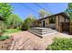 Brick patio and deck offer ample space for outdoor enjoyment in this home's backyard at 3245 S High St, Englewood, CO 80113