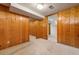 Basement room featuring wood paneled walls, carpeted floor, and window at 3245 S High St, Englewood, CO 80113
