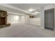 Carpeted basement space with stone fireplace and bar area, offering ample room for entertaining at 3245 S High St, Englewood, CO 80113