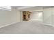 Carpeted basement featuring a stone fireplace, offering a cozy atmosphere at 3245 S High St, Englewood, CO 80113
