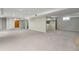Spacious basement with carpet, features a stone fireplace and ample room for storage at 3245 S High St, Englewood, CO 80113