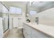 Bathroom featuring a vanity, medicine cabinet, and shower with a sliding glass door at 3245 S High St, Englewood, CO 80113