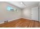 Bright bedroom featuring lustrous wood floors, natural light, and a neutral color palette at 3245 S High St, Englewood, CO 80113