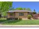 Charming brick home with a well-manicured lawn, trimmed hedges, and a lovely walkway to the front door at 3245 S High St, Englewood, CO 80113
