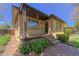 Close up of the brick home's charming front porch with brick steps and wrought iron railing at 3245 S High St, Englewood, CO 80113