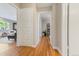 Hallway with hardwood floors, built-in storage, and access to other rooms at 3245 S High St, Englewood, CO 80113