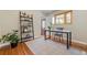 Bright office space with a desk, shelving, and natural light from a window at 3245 S High St, Englewood, CO 80113