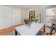 Bright office space features a built-in shelf, crisp white desk, and closet for optimal organization and storage at 3245 S High St, Englewood, CO 80113
