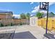 Large backyard featuring partial gravel coverage, a cement patio, a shed, basketball hoop, and wooden privacy fence at 2190 S Uravan St, Aurora, CO 80013