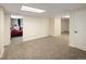 View of the finished basement with neutral carpet and access to the bedroom at 2190 S Uravan St, Aurora, CO 80013