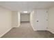 Finished basement area showcasing neutral carpeting and white trim throughout at 2190 S Uravan St, Aurora, CO 80013