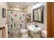 Bathroom featuring a charming floral shower curtain, modern fixtures, and tiled floors at 2190 S Uravan St, Aurora, CO 80013