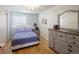 Bright bedroom with ample natural light, a large dresser, and a cozy bed, creating a relaxing atmosphere at 2190 S Uravan St, Aurora, CO 80013