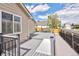 Side view of a gray composite deck with black metal railing and a ramp, plus a swing at 2190 S Uravan St, Aurora, CO 80013