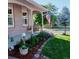 Covered front porch with a swing bench, American flag, landscaping and a charming lamp post and garden at 2190 S Uravan St, Aurora, CO 80013