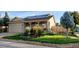 Charming single-story home featuring a well-maintained front yard with lush grass and mature landscaping at 2190 S Uravan St, Aurora, CO 80013