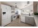 Well-lit kitchen boasts white and gray cabinets, stainless steel appliances, and a built-in desk area for added convenience at 2190 S Uravan St, Aurora, CO 80013