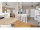 Open-concept kitchen with counter seating and a view into the living room with natural lighting at 2190 S Uravan St, Aurora, CO 80013