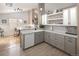 Bright kitchen featuring white cabinets and stainless appliances adjacent to breakfast nook, offering ample counter space at 2190 S Uravan St, Aurora, CO 80013