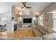 Inviting living room featuring a fireplace, built-in shelving, and comfortable seating on hardwood floors at 2190 S Uravan St, Aurora, CO 80013
