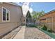 Gravel side yard with a fence, trampoline, and a narrow walkway leading to the backyard of the house at 2190 S Uravan St, Aurora, CO 80013