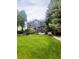 Spacious backyard with lush lawn, mature trees, deck, hot tub, and pergola, perfect for outdoor entertaining at 12742 Clermont St, Thornton, CO 80241