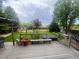 Backyard features a hot tub, swing, and a deck with seating surrounded by green grass and trees at 12742 Clermont St, Thornton, CO 80241