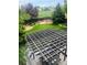 Landscaped backyard featuring a deck, pergola, green grass, and mature trees at 12742 Clermont St, Thornton, CO 80241