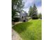 Expansive backyard featuring a well-maintained lawn, mature trees, deck with pergola, and a luxurious hot tub at 12742 Clermont St, Thornton, CO 80241