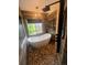 Modern bathroom featuring a freestanding tub, stone tile floor, chandelier and sleek fixtures at 12742 Clermont St, Thornton, CO 80241