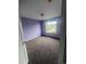 Light-filled bedroom with lilac walls and plush carpet flooring; view from doorway at 12742 Clermont St, Thornton, CO 80241