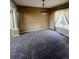 A bright dining room featuring neutral walls, plush carpet, and a large window at 12742 Clermont St, Thornton, CO 80241