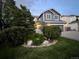 Beautiful two-story home with lush landscaping, manicured lawn, and a two-car garage with brick accents at 12742 Clermont St, Thornton, CO 80241