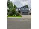 Two-story home with gray siding, brick accents, well-manicured lawn, and attached two-car garage at 12742 Clermont St, Thornton, CO 80241