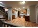 Open kitchen features hardwood floors, wood cabinets, and modern appliances, connected to upper level at 12742 Clermont St, Thornton, CO 80241
