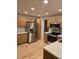 Spacious kitchen with stainless steel appliances, light wood cabinets, and hard wood floors at 12742 Clermont St, Thornton, CO 80241
