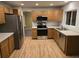 Bright kitchen featuring stainless steel appliances, light wood cabinets, and hard wood floors at 12742 Clermont St, Thornton, CO 80241