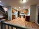 Open-concept kitchen featuring modern appliances, wood cabinets, hardwood floors, and access to upper level at 12742 Clermont St, Thornton, CO 80241