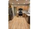 Kitchen featuring stainless steel appliances, light cabinets, and wood floors at 12742 Clermont St, Thornton, CO 80241