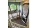 Upstairs view of open living room featuring stone fireplace and large windows at 12742 Clermont St, Thornton, CO 80241