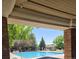 A refreshing community swimming pool with lounge chairs and lush trees under an overhang at 12742 Clermont St, Thornton, CO 80241