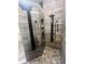 Contemporary shower with dual showerheads, custom tile work, and pebble flooring for spa-like experience at 12742 Clermont St, Thornton, CO 80241