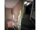 Staircase with gray carpet and white railing leads to a room with gray carpet and ceiling fan at 12742 Clermont St, Thornton, CO 80241